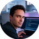 Erco, a data scientist, working on a laptop with AI code in a modern Rome office